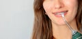 Portrait of young woman with braces on her teeth brushing her teeth with an irrigator. close-up photo. water flosser Royalty Free Stock Photo