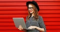 Portrait of young woman in casual working with laptop