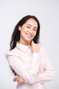 Portrait of a young woman with a charming toothy smile, black hair and brown eyes on a white background in a pink shirt. Positive Royalty Free Stock Photo