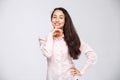 Portrait of a young woman with a charming toothy smile, black hair and brown eyes on a white background in a pink shirt. Positive Royalty Free Stock Photo