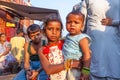 portrait of young woman with child on arm at Meena Bazaar Market in Delhi, India. Shah Jahan founded the bazaar in the 17th