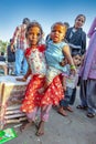 portrait of young woman with child on arm at Meena Bazaar Market in Delhi, India. Shah Jahan founded the bazaar in the 17th