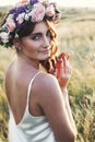 Portrait of young woman with circlet of flowers on head