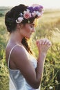Portrait of young woman with circlet of flowers on head Royalty Free Stock Photo