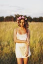 Portrait of young woman with circlet of flowers on head Royalty Free Stock Photo