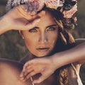 Portrait of young woman with circlet of flowers on head Royalty Free Stock Photo