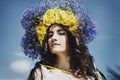 Portrait of young woman with circlet of flowers on head Royalty Free Stock Photo