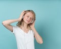 Portrait of young woman listening music via headphones on color neutral tone Aqua Menthe Royalty Free Stock Photo
