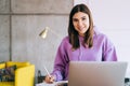 Portrait of young woman college student studying with laptop, distantly preparing for test exam, writing essay doing homework at Royalty Free Stock Photo