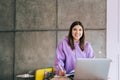 Portrait of young woman college student studying with laptop, distantly preparing for test exam, writing essay doing homework at Royalty Free Stock Photo