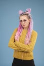 Portrait of young woman with colored colorful hair, with blue background Royalty Free Stock Photo