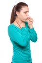 Portrait of an young woman coughing with fist