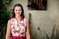 Young woman in dirndl standing in front of farmhouse Royalty Free Stock Photo