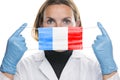 Portrait of a young woman doctor with medical protective mask with the image of the flag of France. Crisis, quarantine, recession
