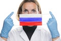 Portrait of a young woman doctor with medical protective mask with the image of the flag of Russia. Crisis, quarantine, recession