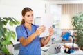 Woman doctor studying clinical diagnosis of patient in medical office Royalty Free Stock Photo