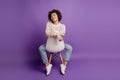 Portrait of young woman dream imagine look empty space sit chair on purple wall