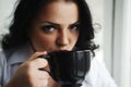 Portrait of young woman drinking a cup of coffee. Royalty Free Stock Photo