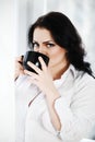 Portrait of young woman drinking a cup of coffee. Royalty Free Stock Photo