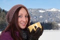 Portrait of a young woman drinking cup of tea in the mountains Royalty Free Stock Photo