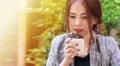 Young woman drinking hot coffee or tea from cup in her hand in morning. Attractive beautiful girl  holding a cup of hot Royalty Free Stock Photo