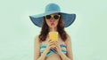 Portrait young woman drinking a juice wearing a straw hat on a beach on a sea background at summer day Royalty Free Stock Photo