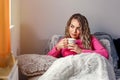 Portrait of young woman drinking tea at home sitting on couch Royalty Free Stock Photo