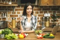 Portrait of a young woman drinking water in the kitchen at home Royalty Free Stock Photo