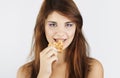 Portrait of young woman eating cookie Royalty Free Stock Photo
