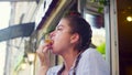 Portrait of young woman eating cookie Royalty Free Stock Photo