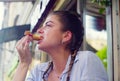 Portrait of young woman eating cookie Royalty Free Stock Photo