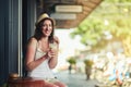 She knows where to go for a caffeine kick. Portrait of a young woman enjoying a chilled coffee beverage while on