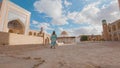 Woman in ethnic dress near Madrassah in Ichan Kala of Khiva