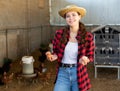 Portrait of woman farmer holding fresh eggs in hands in henhouse