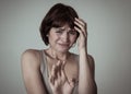 Portrait of a young attractive woman looking scared and shocked.Human expressions and emotions