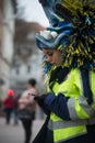 portrait of young woman with a festive costume watching her smartphoone in the street