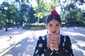 Portrait of young woman flamenco artist, brunette, with typical black flamenco dance suit with white polka dots, playing the palms