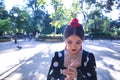 Portrait of young woman flamenco artist, brunette, with typical black flamenco dance suit with white polka dots, playing the palms