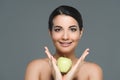 portrait of young woman with fresh apple in hands