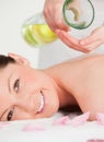 Portrait of a young woman getting massage oil Royalty Free Stock Photo