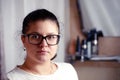 Portrait of young woman in glassess in bathroom