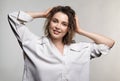 Portrait of young woman on gray background. Female posing in milky white corduroy shirt