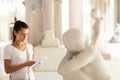 Woman observing sculptures exposition in art museum Royalty Free Stock Photo