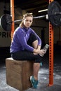 Portrait Of Young Woman In Gym Lifting Weights On Barbell