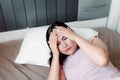 Portrait of Young Woman Having Depression suffering With Headache From Insomnia on Her Bedroom., Healthcare and Medicine Concept Royalty Free Stock Photo