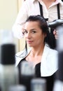 Portrait of young woman having her hair being cut Royalty Free Stock Photo