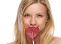 Portrait of young woman with heart shaped lollipop Royalty Free Stock Photo