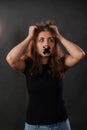 Portrait of a young woman with her mouth sealed with black tape, restriction of freedom of speech, censorship and a ban Royalty Free Stock Photo