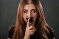 Portrait of a young woman with her mouth sealed with black tape, restriction of freedom of speech, censorship and a ban Royalty Free Stock Photo