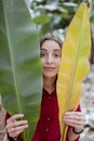 Beautiful woman with banana leaves on the plantation Royalty Free Stock Photo